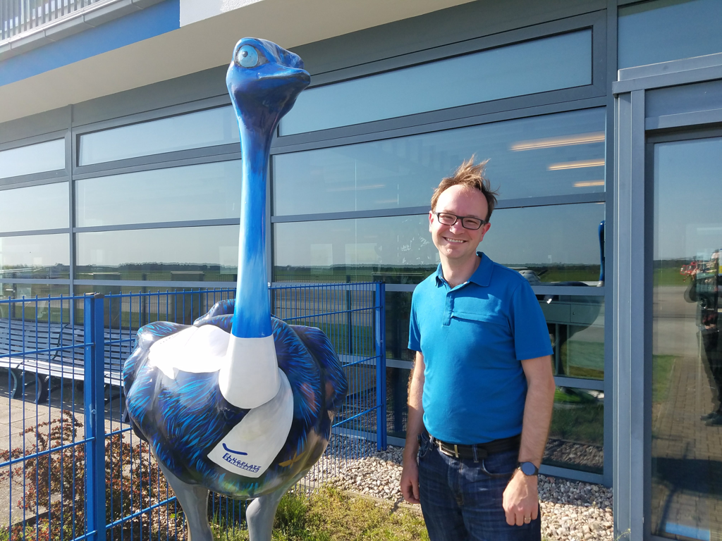 Author posing with the airport's ostrich